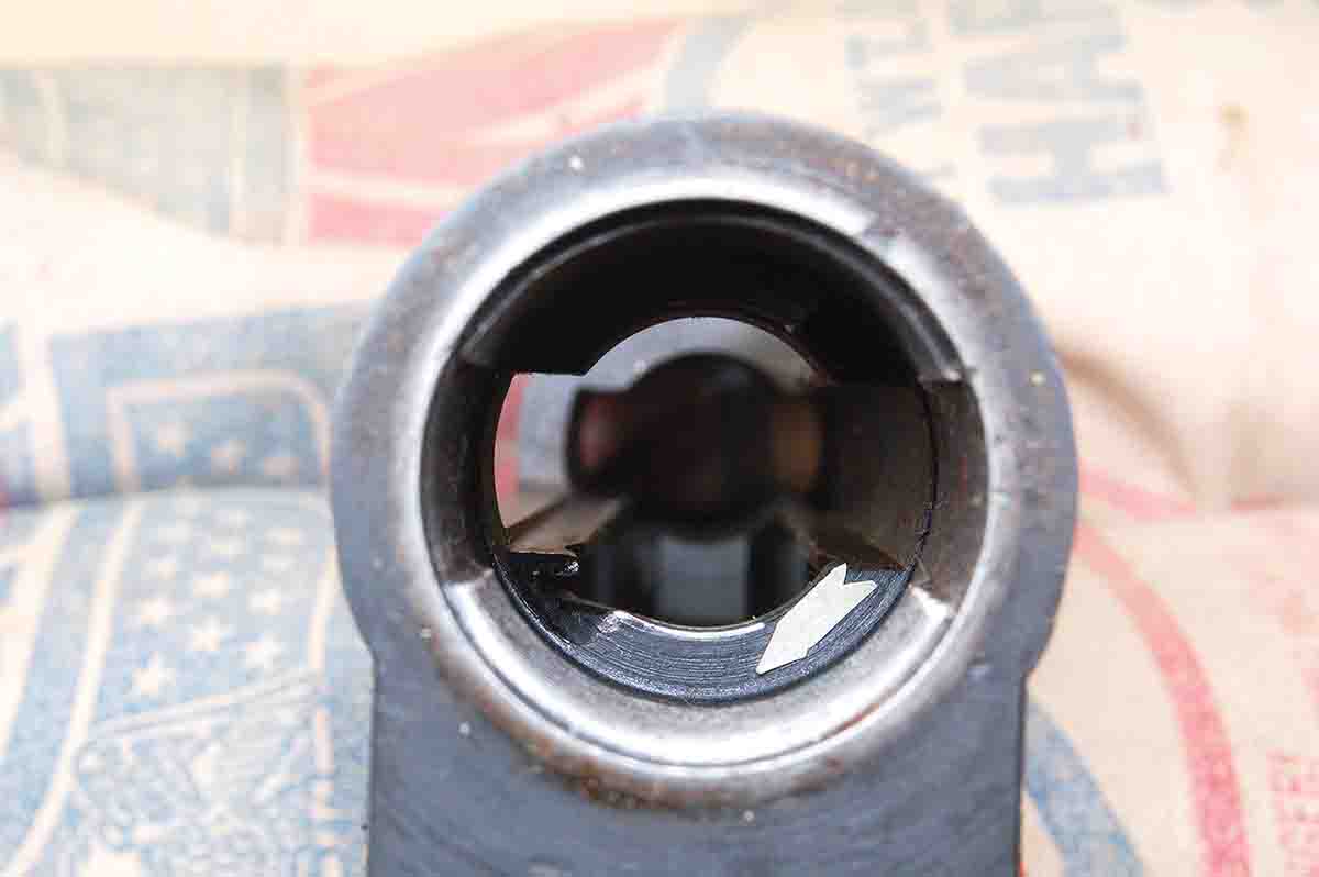 The arrow shows the right-hand bolt lug only contacts the receiver at the tiny bright area where blueing has been worn off.